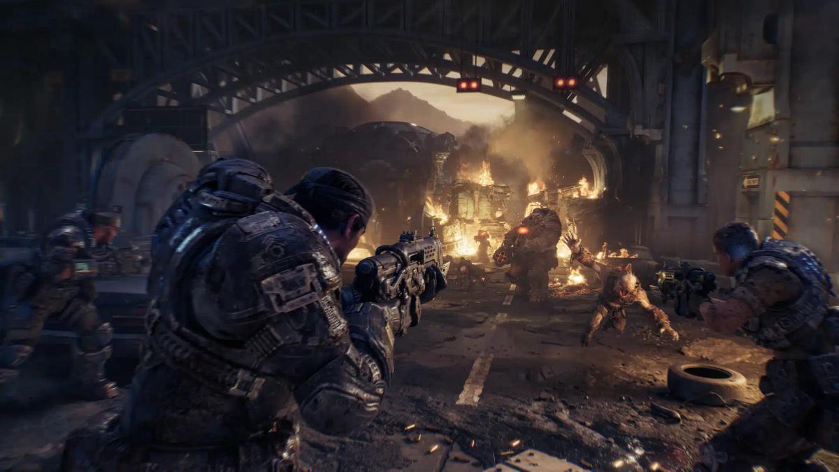 Vojáci v těžké zbroji bojující s monstry v troskách městského prostředí ze hry Gears of War: E-Day.